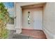 Front entry with white door and sidelight window at 1565 Pasture Ln, Las Vegas, NV 89110