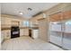 Kitchen with granite counters, black appliances, and backyard access at 1565 Pasture Ln, Las Vegas, NV 89110