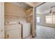 Laundry closet with washer and dryer hookups and shelving at 1565 Pasture Ln, Las Vegas, NV 89110