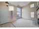 Living room with front door and large windows at 1565 Pasture Ln, Las Vegas, NV 89110