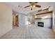 Living room with fireplace and ceiling fan at 1565 Pasture Ln, Las Vegas, NV 89110