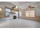 Living room with large windows and fireplace at 1565 Pasture Ln, Las Vegas, NV 89110