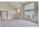 Bright living room with large windows and tile floors at 1565 Pasture Ln, Las Vegas, NV 89110