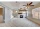 Living room with fireplace and ceiling fan at 1565 Pasture Ln, Las Vegas, NV 89110