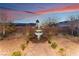 Landscaped backyard with a water fountain at dusk at 16 Via Stefano, Henderson, NV 89011