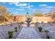 Landscaped backyard with a stone path and fountain at 16 Via Stefano, Henderson, NV 89011