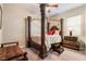 Bedroom with a stately wooden four-poster bed at 16 Via Stefano, Henderson, NV 89011