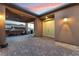 Covered patio with seating area and access to the front door at 16 Via Stefano, Henderson, NV 89011