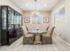 Elegant dining room with a chandelier and glass-top table at 16 Via Stefano, Henderson, NV 89011