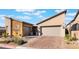 Contemporary home with a two-car garage and brick paver driveway at 16 Via Stefano, Henderson, NV 89011