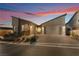 Two-story home with attached garage at dusk at 16 Via Stefano, Henderson, NV 89011