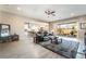 Open living room and kitchen with gray tile floor and cozy seating at 16 Via Stefano, Henderson, NV 89011