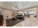 Open living room with a view into the kitchen and backyard at 16 Via Stefano, Henderson, NV 89011