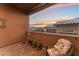 Relaxing patio with wicker chair and mountain view at sunset at 16 Via Stefano, Henderson, NV 89011