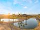 Peaceful pond with palm trees reflecting in the water at sunset at 16 Via Stefano, Henderson, NV 89011