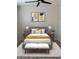 Cozy bedroom with a gray headboard and yellow bedding at 1830 N Buffalo Dr # 1091, Las Vegas, NV 89128