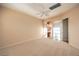 Expansive bedroom with neutral carpeting and a ceiling fan, leading to the ensuite bathroom at 1964 Oliver Springs St, Henderson, NV 89052