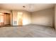 Spacious bedroom featuring neutral carpet, a ceiling fan, and access to an ensuite bathroom at 1964 Oliver Springs St, Henderson, NV 89052