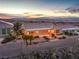 The backyard features decorative rock, manicured landscaping, and a covered outdoor living space at 1964 Oliver Springs St, Henderson, NV 89052