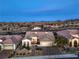 Aerial view of house featuring a well manicured front yard, two car garage and desert landscape at 1964 Oliver Springs St, Henderson, NV 89052