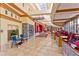 Bright hallway with skylights, colorful decor, shops, seating, and tile flooring at 1964 Oliver Springs St, Henderson, NV 89052