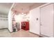 Laundry room with modern red washer and dryer set, utility sink, and storage shelving at 1964 Oliver Springs St, Henderson, NV 89052