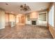 Open-concept living room with fireplace, custom built-ins and a ceiling fan for added comfort at 1964 Oliver Springs St, Henderson, NV 89052