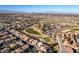 Aerial view showcasing houses and a golf course in a residential area at 2412 Eagleridge Dr, Henderson, NV 89074