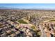 Wide aerial view of house and surrounding community, including golf course at 2412 Eagleridge Dr, Henderson, NV 89074