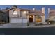 Two-story house with a large front yard, two-car garage, and attractive landscaping at 2412 Eagleridge Dr, Henderson, NV 89074