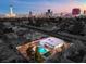 House with pool, aerial view, showing a city skyline in the background at 2500 W Oakey Blvd, Las Vegas, NV 89102