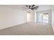 Bedroom with grey carpet, ceiling fan and access to backyard at 2500 W Oakey Blvd, Las Vegas, NV 89102