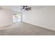 Bright bedroom with grey carpet, ceiling fan and sliding glass door at 2500 W Oakey Blvd, Las Vegas, NV 89102