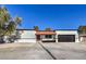 Single story home with red door, black garage door, and small front yard at 2500 W Oakey Blvd, Las Vegas, NV 89102