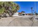 Landscaped yard with driveway and a tree next to the house at 2500 W Oakey Blvd, Las Vegas, NV 89102