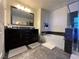 Bathroom with double vanity, soaking tub, and dark cabinets at 3029 Camino Sereno Ave, Henderson, NV 89044