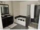 Bathroom with soaking tub, shower, and dark vanity at 3029 Camino Sereno Ave, Henderson, NV 89044