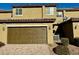 Tan two-story townhome with a two-car garage at 3029 Camino Sereno Ave, Henderson, NV 89044