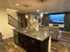 Kitchen island with granite countertop and dark cabinets at 3029 Camino Sereno Ave, Henderson, NV 89044