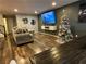 Living room with hardwood floors, large TV, and Christmas tree at 3029 Camino Sereno Ave, Henderson, NV 89044