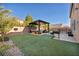 Spacious backyard with artificial turf, pergola, and hot tub at 5728 Collier Falls Ave, Las Vegas, NV 89139