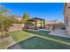 Landscaped backyard with covered patio and artificial turf at 5728 Collier Falls Ave, Las Vegas, NV 89139