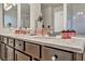 Double vanity bathroom with dark brown cabinets and a large vanity top at 5728 Collier Falls Ave, Las Vegas, NV 89139