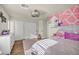 Bright bedroom with pink accents, a large bed, and plenty of closet space at 5728 Collier Falls Ave, Las Vegas, NV 89139