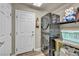 Laundry room with stackable washer and dryer, and built-in shelving at 5728 Collier Falls Ave, Las Vegas, NV 89139