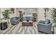 Bright living room with gray armchairs, wood-like flooring, and a large coffee table at 5728 Collier Falls Ave, Las Vegas, NV 89139