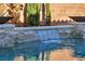 Inviting pool with a waterfall feature and stone coping at 5728 Collier Falls Ave, Las Vegas, NV 89139