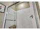 Bathroom shower with glass enclosure and marble walls at 5728 Collier Falls Ave, Las Vegas, NV 89139