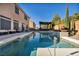 Relaxing pool area with a pergola, spa, and plenty of outdoor seating at 5728 Collier Falls Ave, Las Vegas, NV 89139