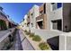 Pathway through a community of modern townhomes with landscaping at 600 N Carriage Hill Dr # 1113, Las Vegas, NV 89138